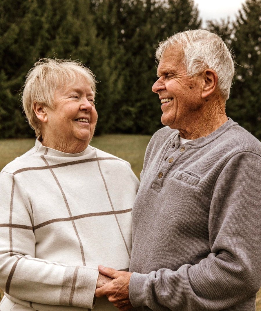 Wendy and Jack Sparks, Shane's parents, holding hands outdoors
